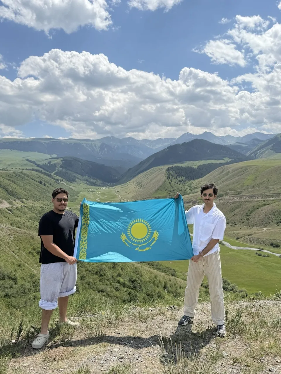 Our guests with the Kazakh national flag in the mountains